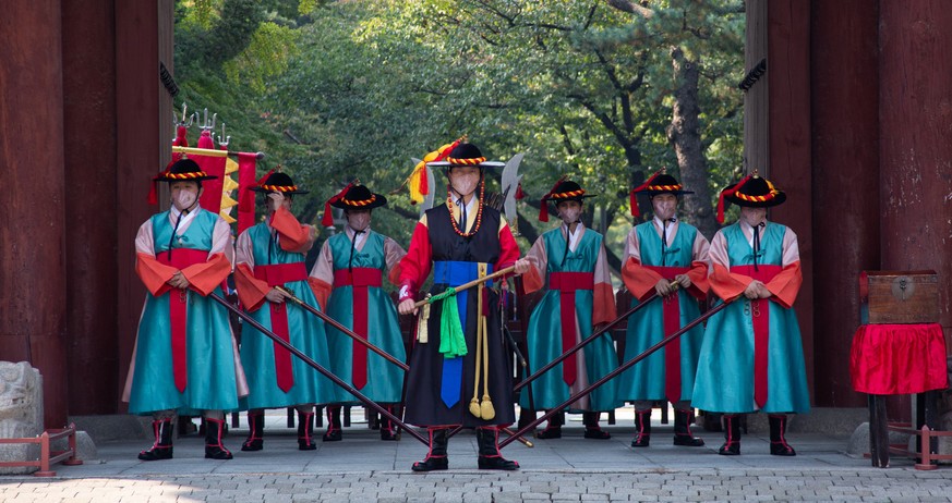 epa08758353 South Korean officials wearing Royal Guard uniforms perform the changing of the guard ceremony at Deoksugung Palace in Seoul, South Korea, 20 October 2020. The Royal Guard Changing Ceremon ...