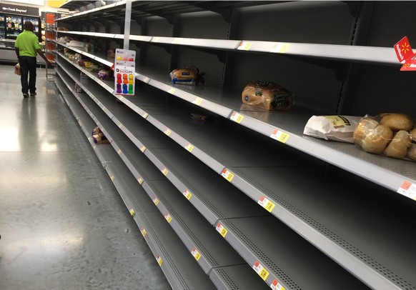 Shelves usually stocked with bread and bottled water are barren early Thursday, Oct. 6, 2016, at the Walmart on W. Broward Blvd. in Fort Lauderdale, Fla., as Hurricane Matthew approaches (Emily Miller ...