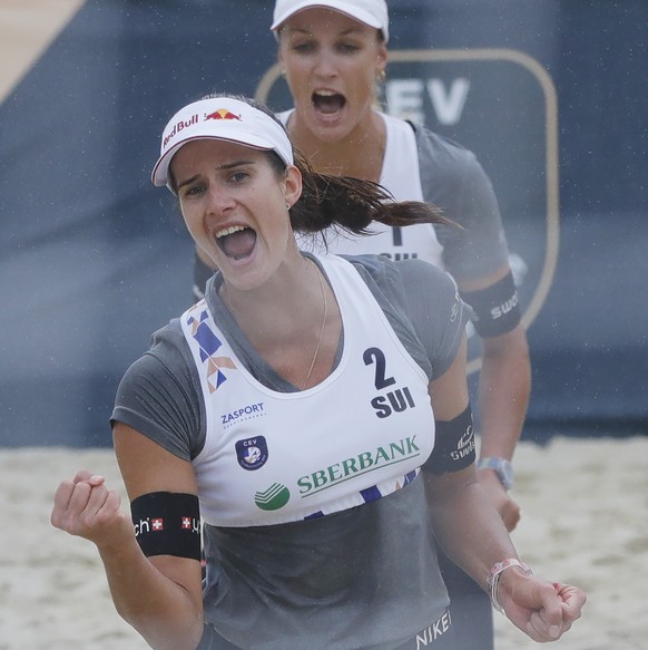 Switzerland&#039;s Joana Heidrich, foreground, and Anouk Verge-Depre react during the Beach Volleyball European Championship round of 16 match against Germany&#039;s Kim Behrens and Cinja Tillmann in  ...