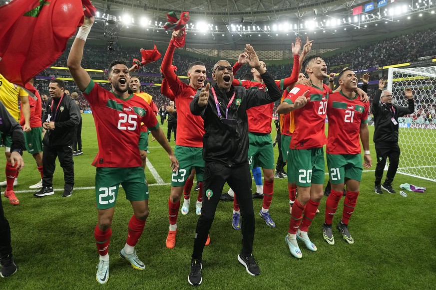 Morocco&#039;s players celebrate after the World Cup quarterfinal soccer match between Morocco and Portugal, at Al Thumama Stadium in Doha, Qatar, Saturday, Dec. 10, 2022. (AP Photo/Martin Meissner)