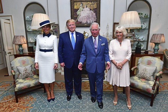 US President Donald Trump and his wife Melania, left, pose for a photo with Britain&#039;s Prince Charles and Camilla, the Duchess of Cornwall prior to afternoon tea at Clarence House, in London, Mond ...