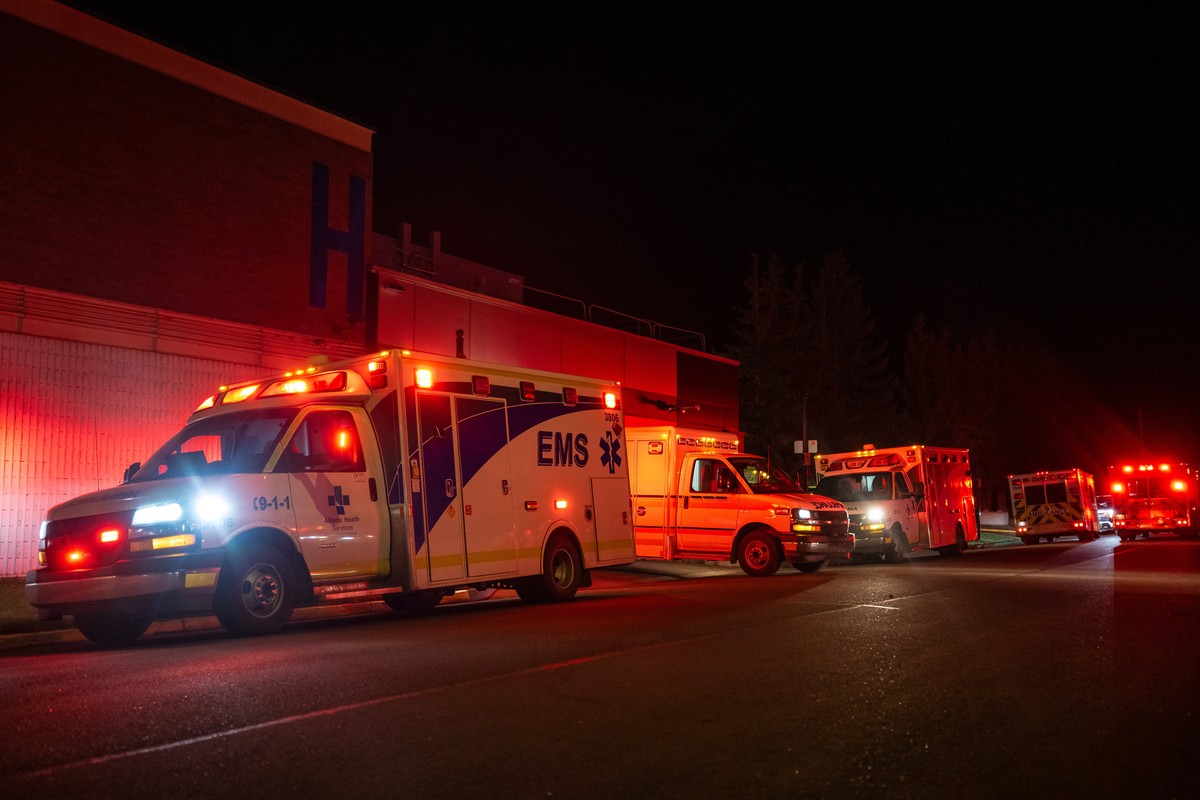 Emergency crews and military personnel gather at the Wainwright Health Centre as injured military members are treated after a fire at Canadian Forces Base Wainwright, outside of Wainwright, Alberta Sa ...