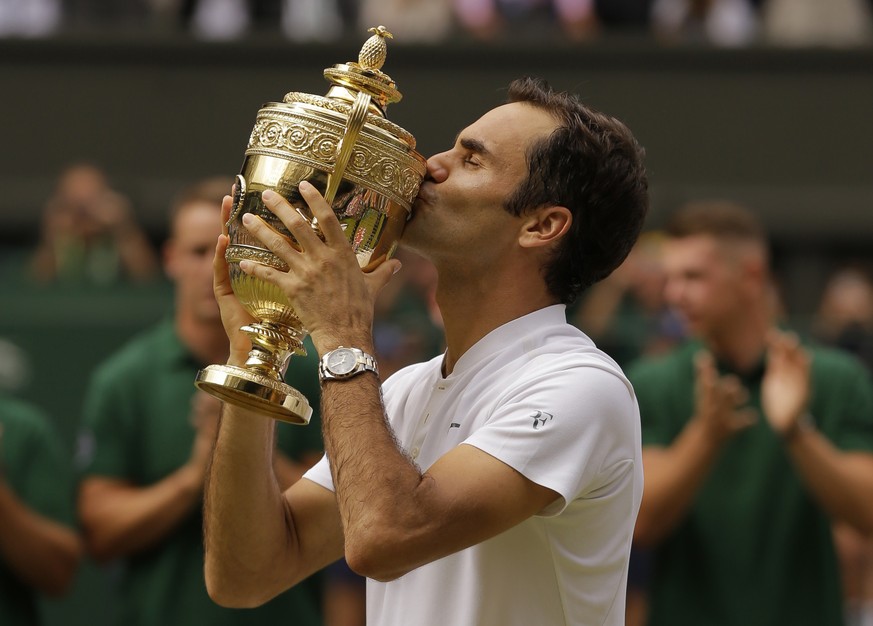 FILE - In this July 16, 2017, file photo, Switzerland&#039;s Roger Federer kisses the trophy after defeating Croatia&#039;s Marin Cilic to win the Men&#039;s Singles final match at the Wimbledon Tenni ...