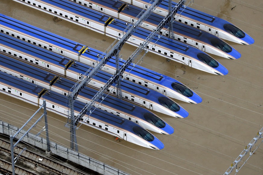 Bullet trains are seen submerged in muddy waters in Nagano, central Japan, after Typhoon Hagibis hit the city, Sunday, Oct. 13, 2019. Rescue efforts for people stranded in flooded areas are in full fo ...