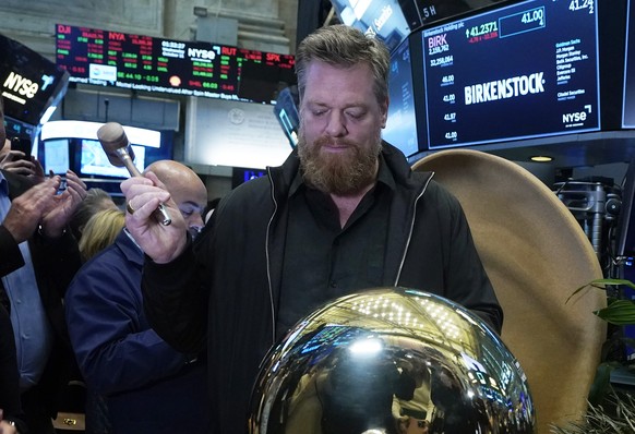 Birkenstock CEO Oliver Reichert rings a ceremonial bell on the the New York Stock Exchange floor as his company&#039;s IPO begins trading, Wednesday, Oct. 11, 2023. (AP Photo/Richard Drew)