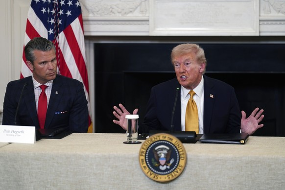 epa12477192 US President Donald Trump (R) and US Secretary of Defense Pete Hegseth (L) during a roundtable with the Homeland Security Task Force in the State Dining Room of the White House in Washingt ...