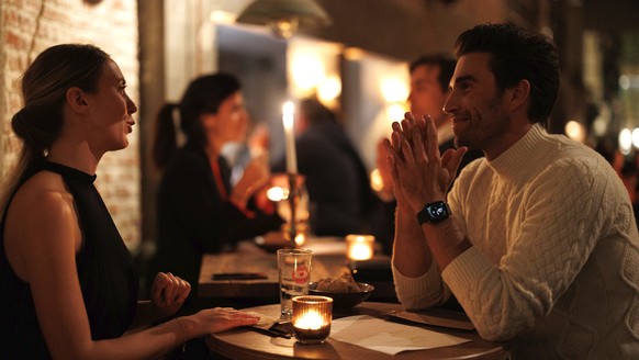 A group of diners have a drink and candle lit dinner at Brasserie Surrealiste in Brussels, Wednesday, Sept. 28, 2022. A group of restaurant owners in Brussels has imagined how a future without gas and ...