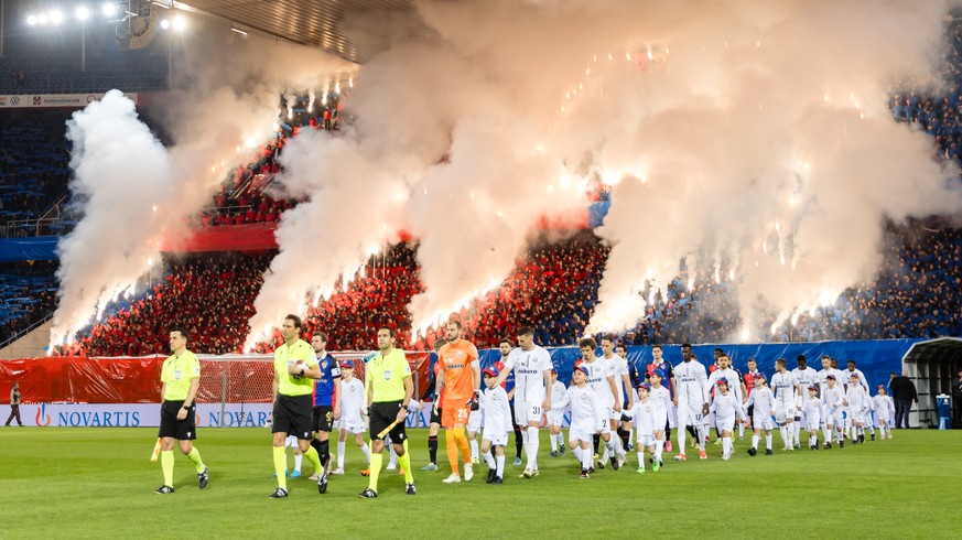 Die Spieler vom FC Basel und vom FC Zuerich betreten das Spielfeld waehrend die Fans Pyros zuenden vor dem Fussball Meisterschaftsspiel der Super League zwischen dem FC Basel und dem FC Zuerich am Sam ...