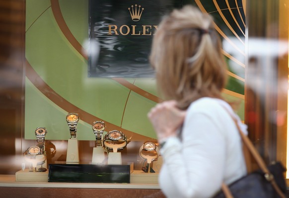 CHICAGO, IL - JULY 29: A woman looks over Rolex watches offered for sale in a store along a section of Michigan Avenue known as the Magnificent Mile on July 29, 2014 in Chicago, Illinois. As the job m ...