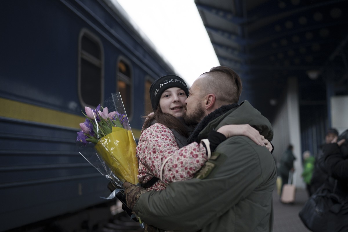 Ukrainian soldier Vasyl Khomko, 42, hugs his daughter Yana as she arrives at the train station in Kyiv, Ukraine, Saturday, Dec. 31, 2022. Khomko's wife and daughter have been living in Slovakia d ...