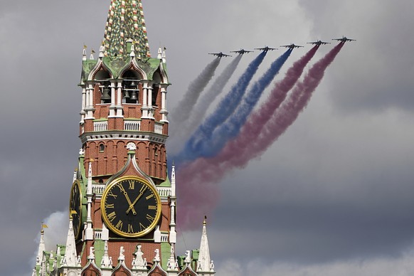 Russian Air Force Su-25 jets fly over Red Square leaving trails of smoke in the colors of the Russian national flag during the Victory Day military parade rehearsal with the Spasskaya Tower in Moscow, ...