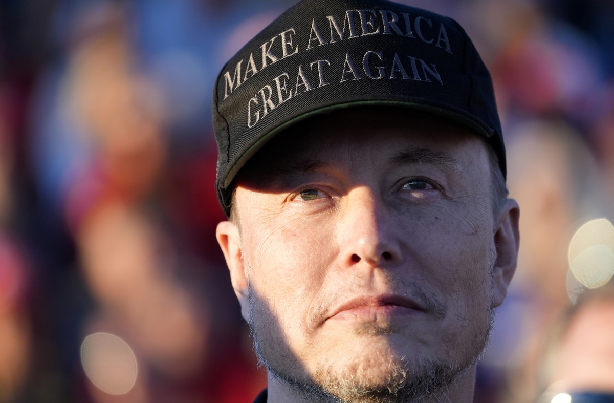 FILE - Tesla and SpaceX CEO Elon Musk listens as Republican presidential nominee former President Donald Trump speaks at a campaign event at the Butler Farm Show, Oct. 5, 2024, in Butler, Pa. (AP Phot ...