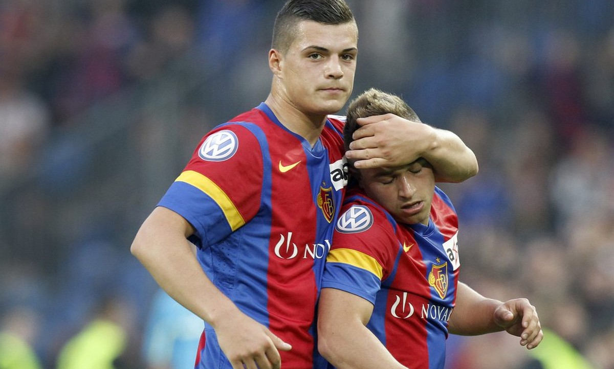 Basel's Granit Xhaka, left, holds Xherdan Shaqiri, right, during the Super League soccer match between FC Basel and BSC Young Boys at the St. Jakob-Park stadium in Basel, Switzerland, on Wednesda ...