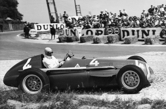 FILE - In this July 1, 1951 file photo Juan Manuel Fangio comes out of a bend at speed during the race, driving a supercharged 1.5 Liter Alfa Romeo during the Grand Prix D&#039;Europe at Rheims, Franc ...