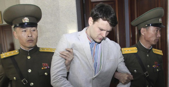In this March 16, 2016, file photo, American student Otto Warmbier, center, is escorted at the Supreme Court in Pyongyang, North Korea. North Korea announced Warmbier's detention Jan. 22, 2016, and th ...