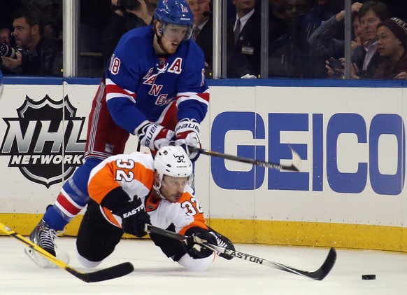 NEW YORK, NY - APRIL 30: Mark Streit #32 of the Philadelphia Flyers moves the puck ahead of Marc Staal #18 of the New York Rangers in Game Seven of the First Round of the 2014 NHL Stanley Cup Playoffs ...