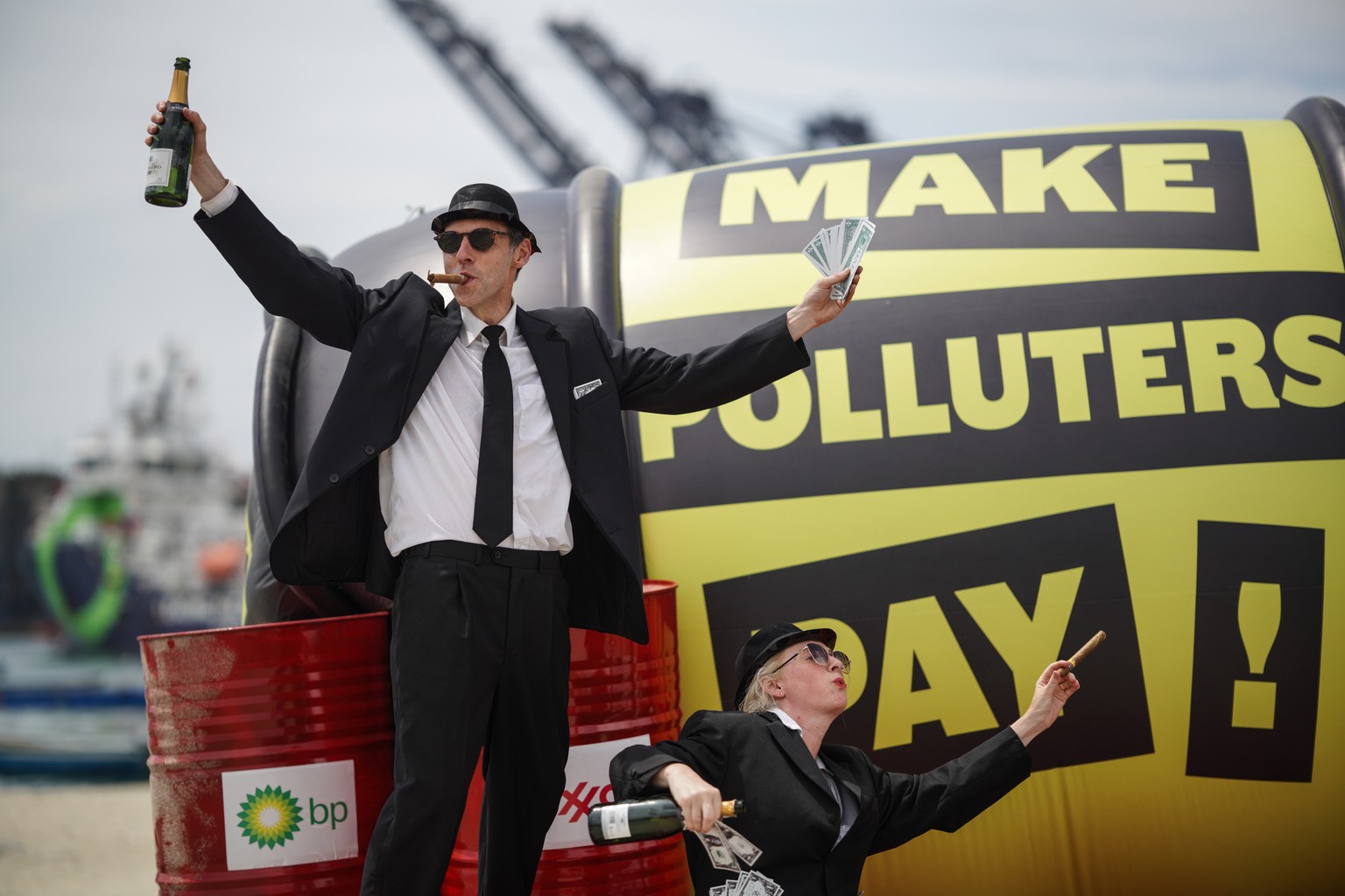 Demonstrators participate in a Make Polluters Pay campaign along the Caribbean Sea demanding oil companies pay for the energy transition during a nearby conference aimed at transitioning away from fos ...