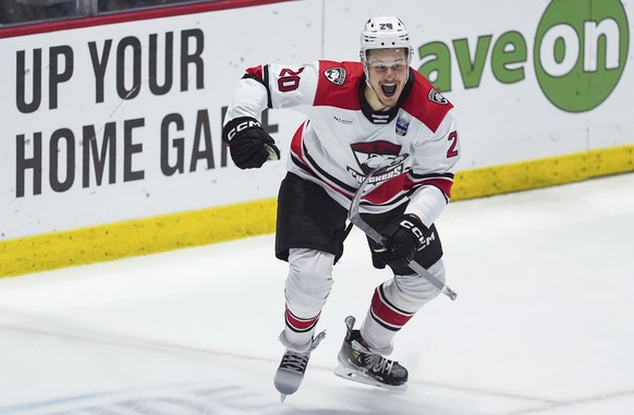 Charlotte Checkers&#039; Jesse Puljujarvi celebrates his winning goal against the Abbotsford Canucks during the first overtime period in Game 5 of the AHL hockey Calder Cup Final, in Abbotsford, Briti ...