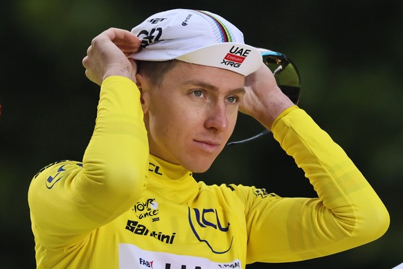 epa12266532 Slovenian rider Tadej Pogacar of UAE Team Emirates wearing the yellow jersey for overall leader celebrates on the podium his victory after the 21st and last stage of the Tour de France cyc ...