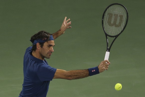 Roger Federer of Switzerland returns the ball to Philipp Kohlschreiber of Germany during their match at the Dubai Duty Free Tennis Championship, in Dubai, United Arab Emirates, Monday, Feb. 25, 2019.  ...