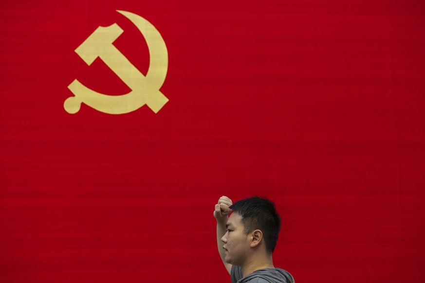 epa09314824 A man renew his vow to the Communist Party of China in the Memorial of the 1st National Congress of the CPC (Chinese Communist Party), in Shanghai, China, 01 July 2021. China celebrates on ...