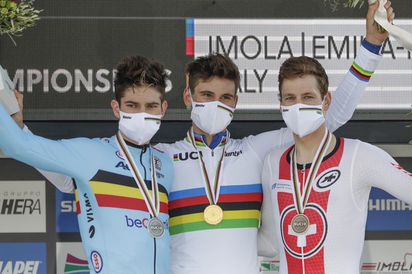 Italy&#039;s Filippo Ganna, center, winner of the men&#039;s Individual Time Trial event, poses on the podium with second placed Belgium&#039;s Wout van Aert, left, and third placed Switzerland&#039;s ...