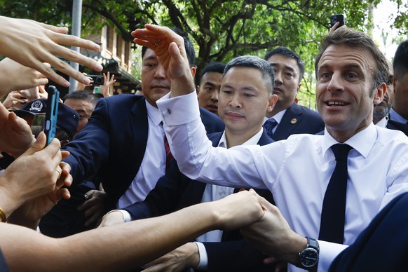 French President Emmanuel Macron arrives to attend a visit at Sun Yat-sen University in Guangzhou, China, Friday, April 7, 2023. (Gonzalo Fuentes/Pool Photo via AP)