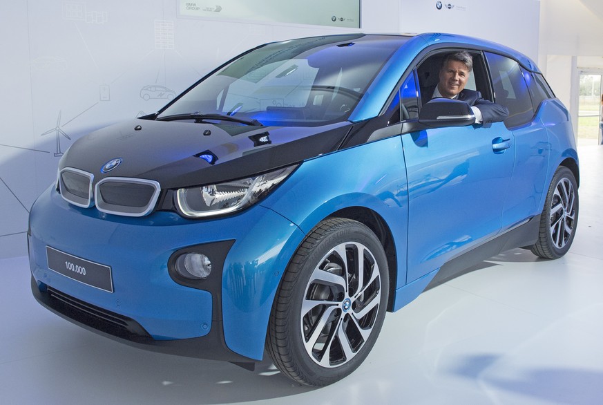 Harald Krueger, CEO of car manufacturer BMW, sits in a BMW i3 car after after it left the assembly line during the production anniversary of the 100,000th electric car at the plant of German luxury au ...