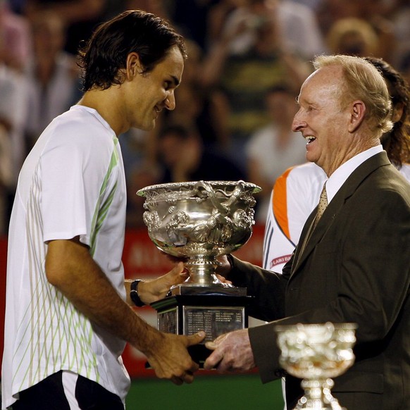 Switzerland's Roger Federer (L) receives the winning trophy from Rod Laver after defeating Marcos Baghdatis from Cyprus in the men's singles final at the Australian Open Tennis in Melbourne, Sunday, 2 ...