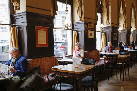 People sit in the reopen coffeehouse ÄûCafe Sperl&quot; in Vienna, Austria, Wednesday, May 19, 2021. As a part of the relaxing of the measures to combat the coronavirus, the gastronomy in the Austria ...