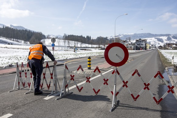 Ein Polizist sperrt die Luzernerstrasse in Malters, am Mittwoch, 9. Maerz 2016. Eine 65-jaehrige Frau hat sich seit Dienstag in einem Haus in Malters verschanzt. Die Polizei hat das Haus umstellen mue ...