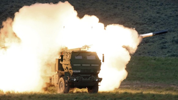 FILE - In this May 23, 2011, file photo a launch truck fires the High Mobility Artillery Rocket System (HIMARS) produced by Lockheed Martin during combat training in the high desert of the Yakima Trai ...