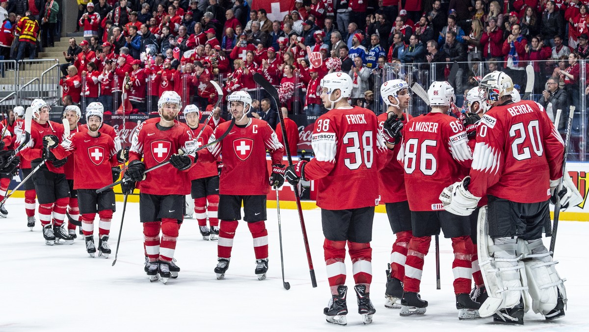 epa07571070 Switzerland's players celebrate after the IIHF World Championship group B ice hockey match between Switzerland and Austria at the Ondrej Nepela Arena in Bratislava, Slovakia, 14 May 2 ...