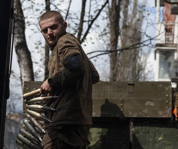FILE - A Ukrainian soldier carries cartridges in war-hit Bakhmut, Donetsk region, Ukraine, Sunday, April 23, 2023. Ukrainian President Volodymyr Zelenskyy said Sunday, May 21, 2023 that Russian forces ...