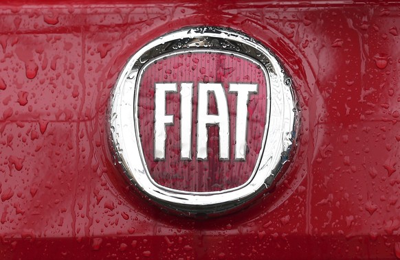 FILE - In this Jan. 2, 2014 file photo, a Fiat logo pictured on a car in Milan, Italy. Italian-American carmaker Fiat Chrysler Automobiles on Wednesday, Oct. 30, 2019 confirmed that it is in talks wit ...