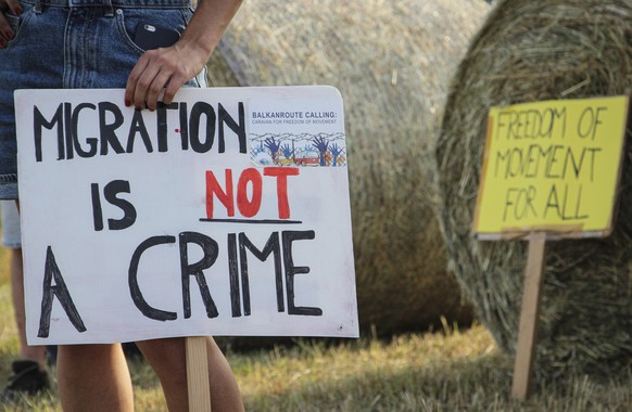 A woman holds a banner during a protest against the violent pushbacks of migrants, allegedly conducted by Croatian police, near the border crossing between Croatia and Bosnia Herzegovina in Maljevac,  ...