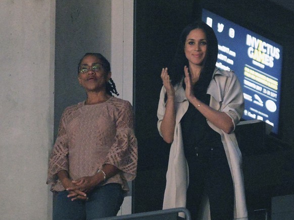 FILE - In this Saturday, Sept. 30, 2017 file photo, Meghan Markle, right, watches the closing ceremonies of the Invictus Games with her mother Doria Ragland in Toronto. Royal officials say Meghan Mark ...