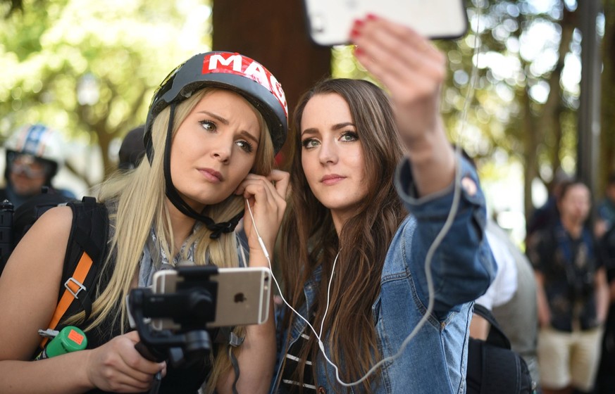 April 27, 2017 - Berkeley, California, U.S - Alt-right videocasters LAUREN SOUTHERN and BRITTANY PETTIBONE broadcast from the sight of an alt-right MAGA rally at Berkeley s Civic Center Park.