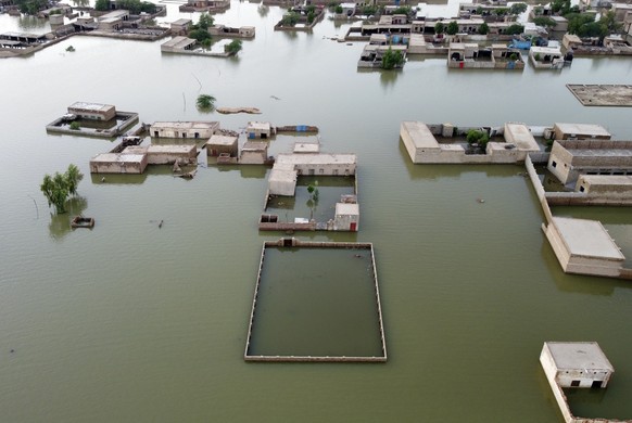 Homes are surrounded by floodwaters in Jaffarabad, a district of Pakistan's southwestern Baluchistan province, Thursday, Sept. 1, 2022. Pakistani health officials on Thursday reported an outbreak of w ...