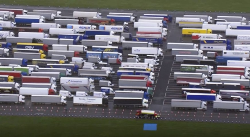 Trucks are parked in a holding area, in this aerial photo taken from video, lined up at former airfield in Manston, England, close to the M20 highway that runs to the port of Dover, Britain&#039;s mai ...