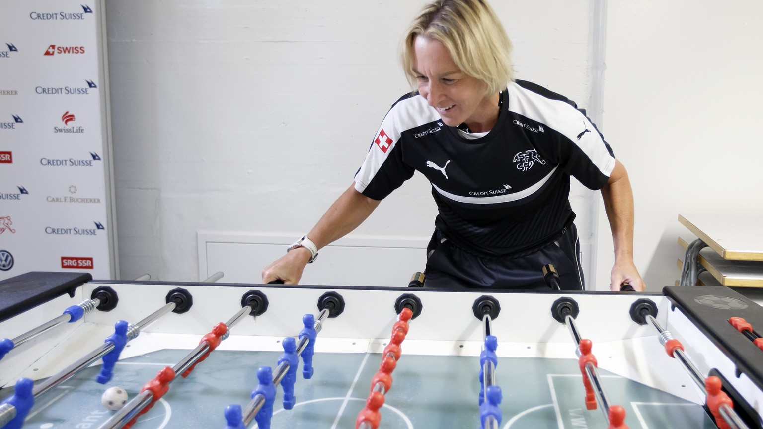 Switzerland&#039;s head coach Martina Voss-Tecklenburg plays to table football prior a training session, one day before an international friendly test match between the national soccer teams of Switze ...