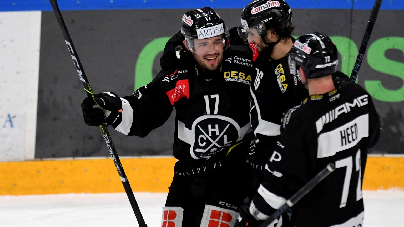Lugano&#039;s player Luca Fazzini left celebrates the 4 - 3 goal with Team mate, during the preliminary round game of National League A (NLA) Swiss Championship 2020/21 between HC Lugano against LHC L ...