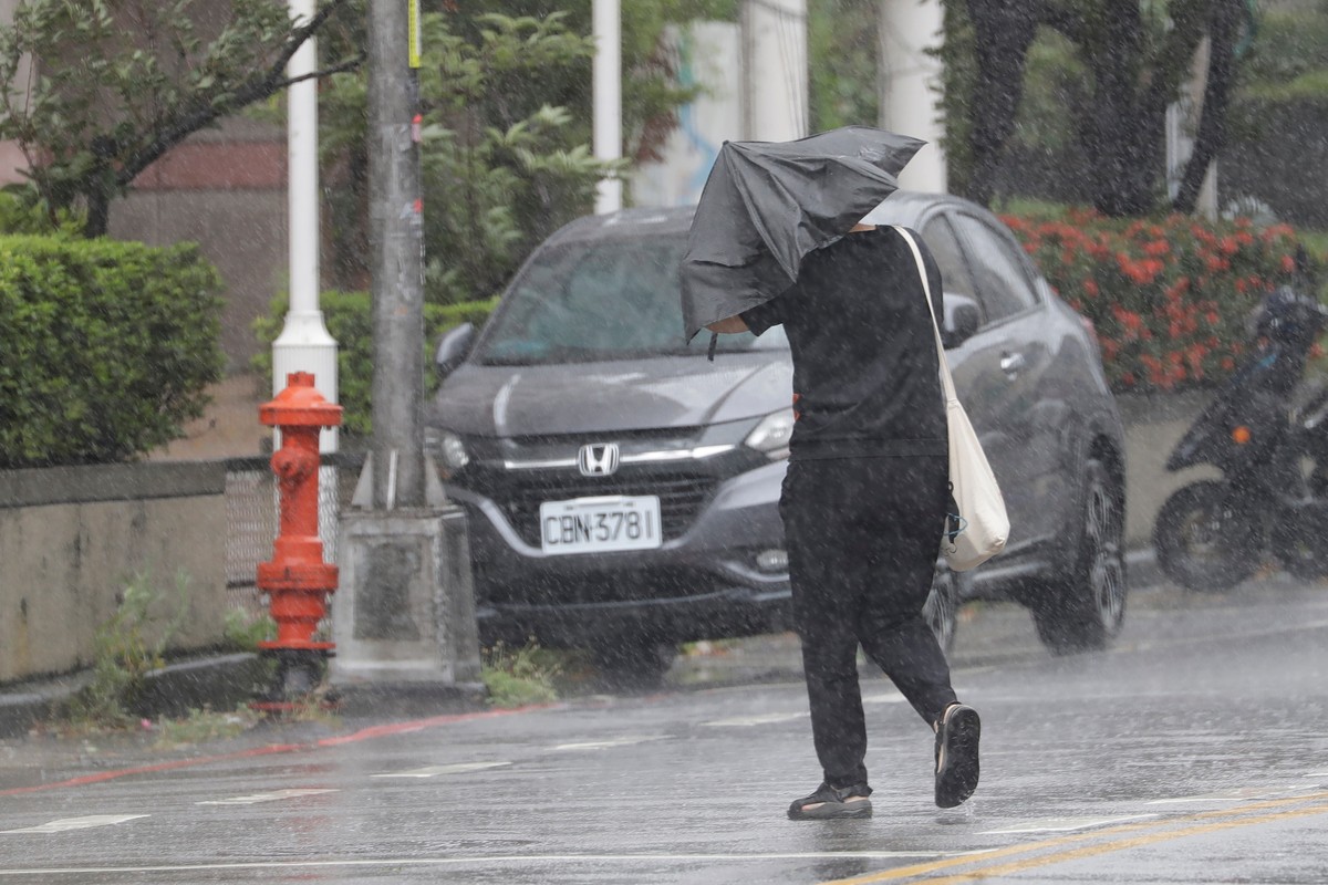 A person walks in a rain caused by Typhoon Bavi in Taichung, Taiwan, Saturday, July 11, 2026. (AP Photo/Chiang Ying-ying)
Taiwan Extreme Weather Asia Storms