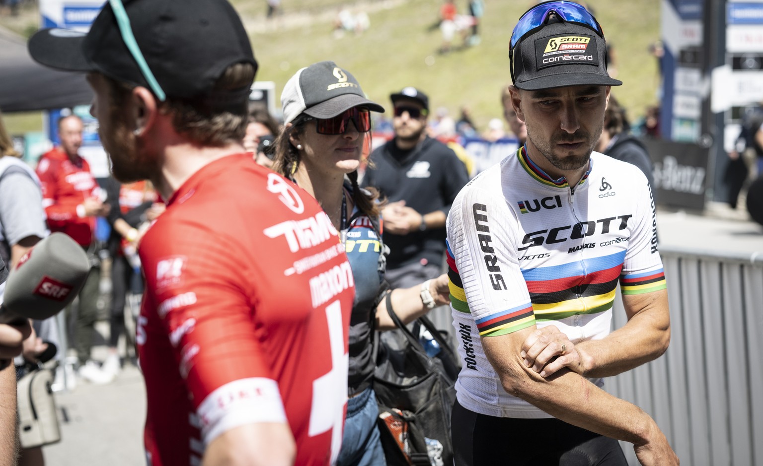 Nino Schurter, right, and Mathias Flueckiger of Switzerland react after crashing during the final lap at the UCI Cross Country Mountain Bike race, on Sunday, July 10, 2022, in Lenzerheide, Switzerland ...