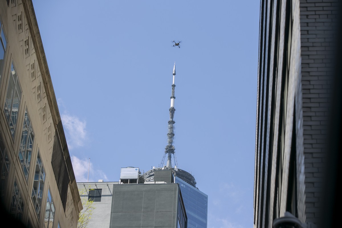 FILE - An NYPD or FDNY drone flies over the site of a partially collapsed parking garage as One World Trade Center is visible in the background in New York City, April 19, 2023. The New York City poli ...