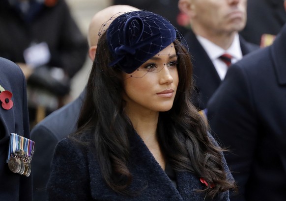 FILE - In this Thursday, Nov. 7, 2019 file photo Meghan the Duchess of Sussex stands after she and her husband Britain&#039;s Prince Harry placed a Cross of Remembrance as they attend the official ope ...