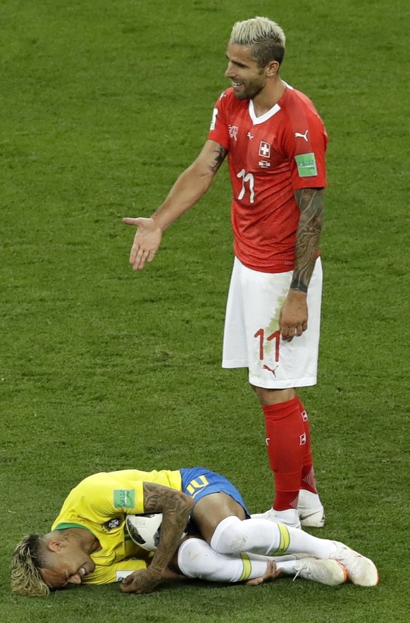 Switzerland's Valon Behrami reacts as Brazil's Neymar lies on the ground during the group E match between Brazil and Switzerland at the 2018 soccer World Cup in the Rostov Arena in Rostov-on-Don, Russ ...