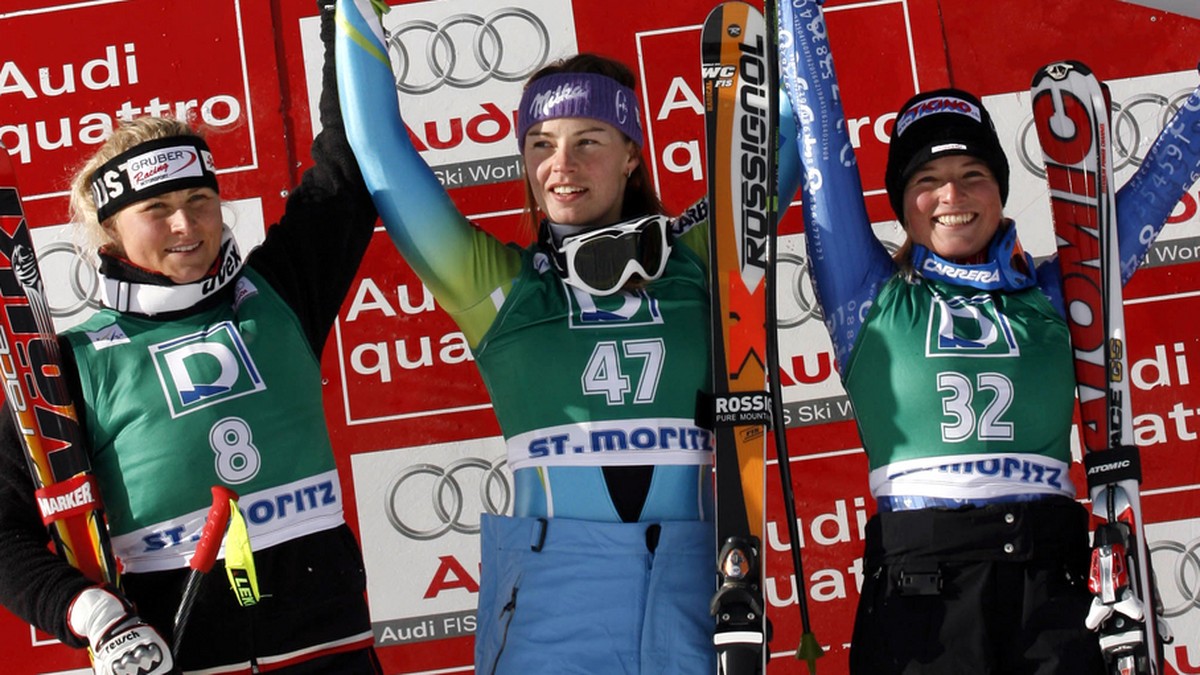 Tina Maze, of Slovenia, center, winner of an alpine ski, women's World Cup Downhill race, celebrates on the podium with second placed Maria Holaus, of Austria, left, and third placed Lara Gut, of ...