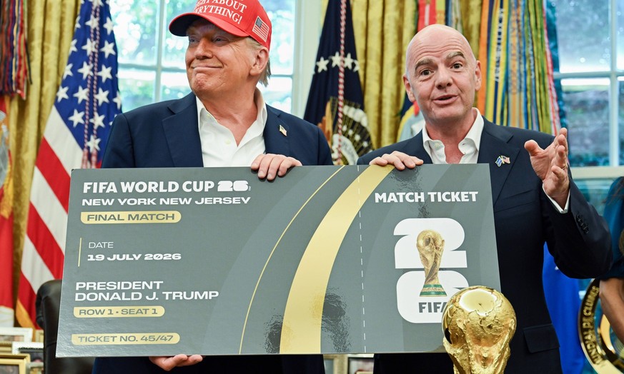 President Donald Trump and FIFA President Gianni Infantino hold a ticket to the 2026 FIFA World Cup after after announcing the 2026 World Cup draw will be held at the Kennedy Center in December in the ...