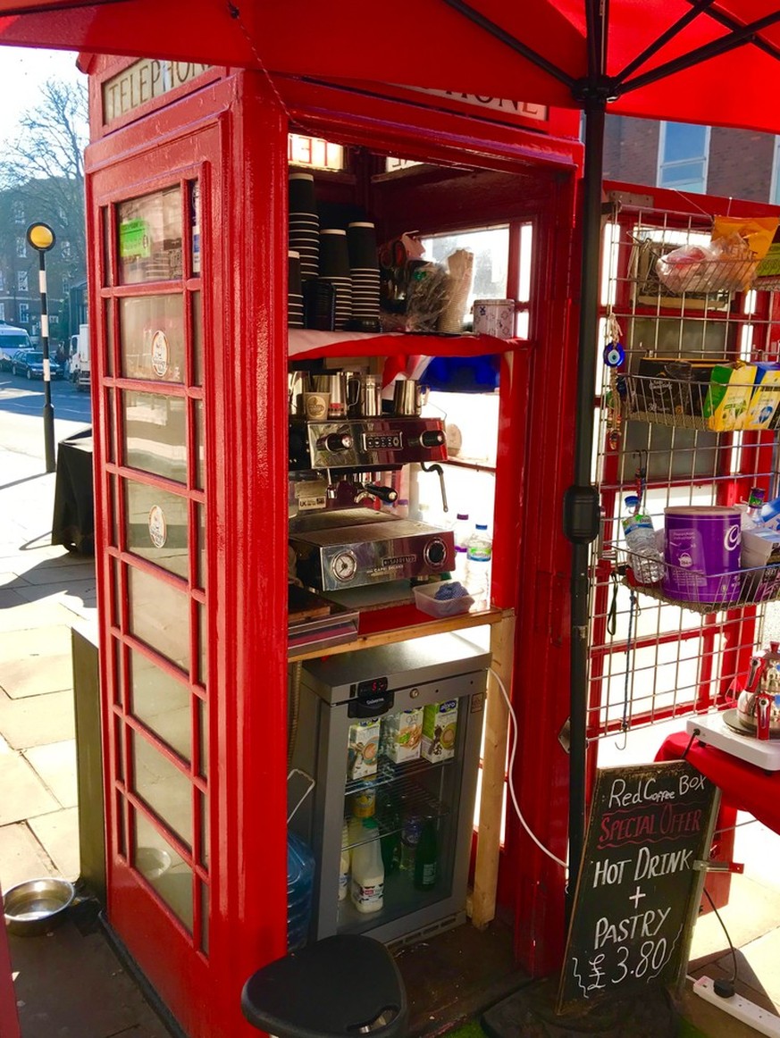 London, London / United Kingdom - March 1 2019: Kape Barako red telephone booth coffee shop Hampstead